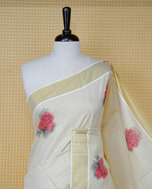Cream Colour Tissue Kerala  Saree Featuring A Digital  Rose Printed Body &  Pallu ,  Beautifully Enhanced With A Classic Gold Zari Border And  Black & Red  Tassels, Paired With A Matching Blouse Piece.