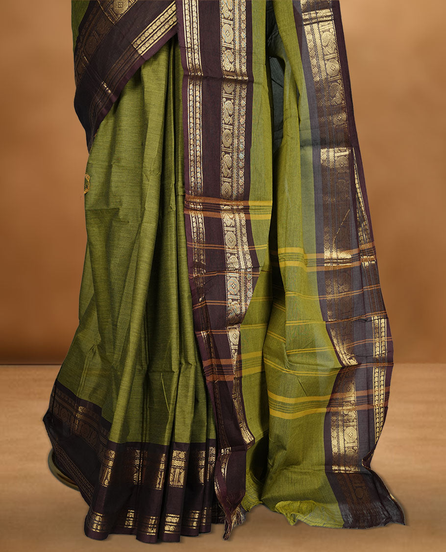 Olive colour chettinad cotton saree featuring plain body, contrast chocolate brown colour with traditional gold zari border paired with matching blouse.