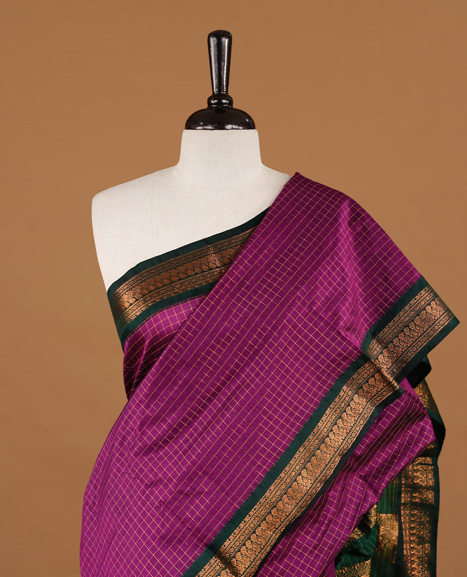 Purple colour kalyani cotton saree featuring gold zari check pattern on body, highlighting contrast green colour with Antique gold zari border, paired with matching blouse piece.