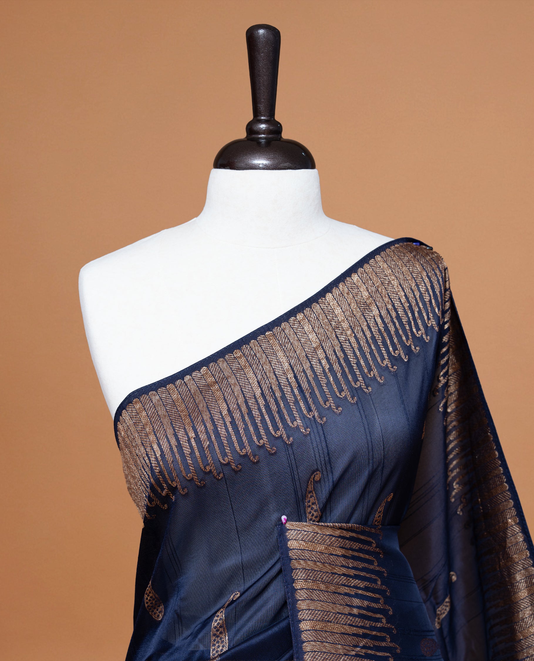 Navy Blue colour Semi Banaras Tussar Georgette Featuring Gold zari Leaf pattern on body, Finished with Gold zari border and paired with matching blouse piece.