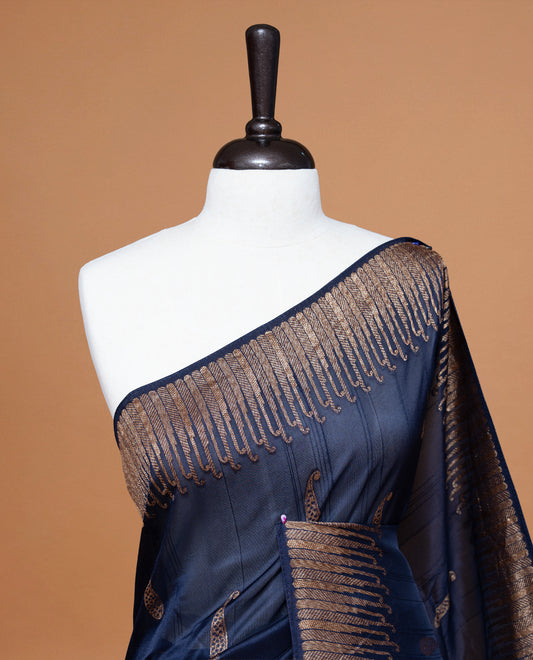 Navy Blue colour Semi Banaras Tussar Georgette Featuring Gold zari Leaf pattern on body, Finished with Gold zari border and paired with matching blouse piece.