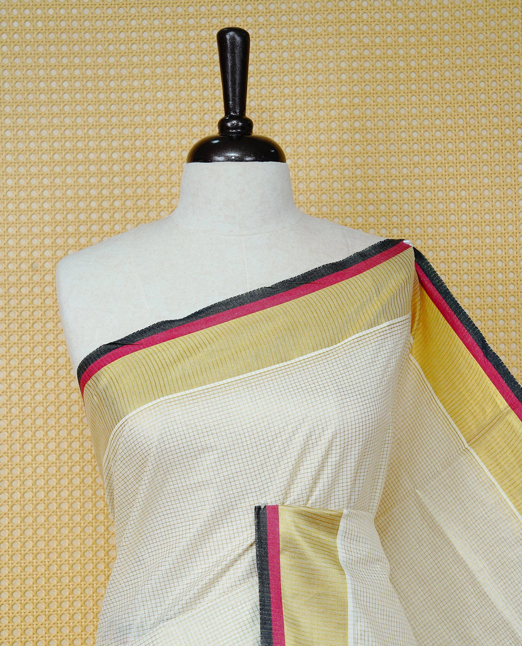 Cream colour cotton Kerala saree Featuring Gold zari Checks across the body, complemented by Classy Gold zari with an Maroon  &  Black  Border & pallu, paired with a matching blouse piece.