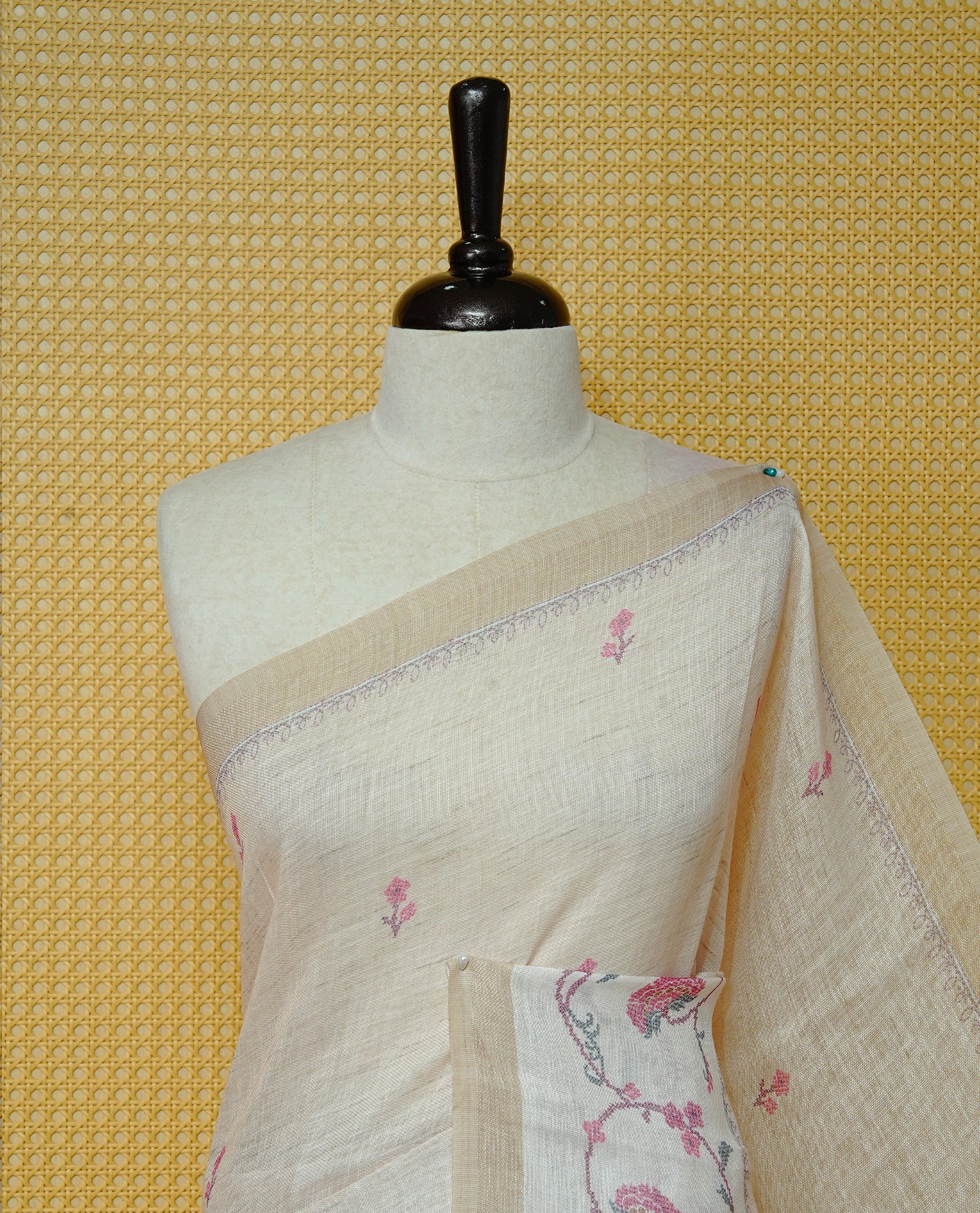 Cream colour semi linen saree featuring Floral printed buttas on body, complemented by contrast Pale Yellow colour border, comes with matching blouse piece.