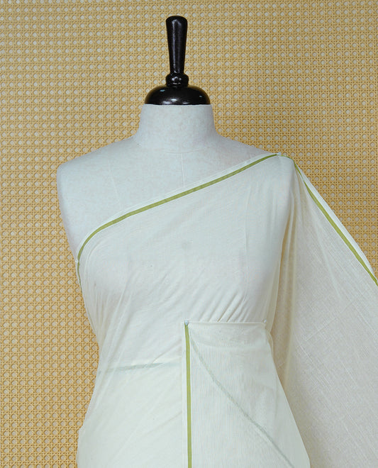 Cream colour cotton Kerala saree Featuring Classy Plain body for Effortless Elegance, enhancing Minimalist Green border, paired with matching blouse piece.