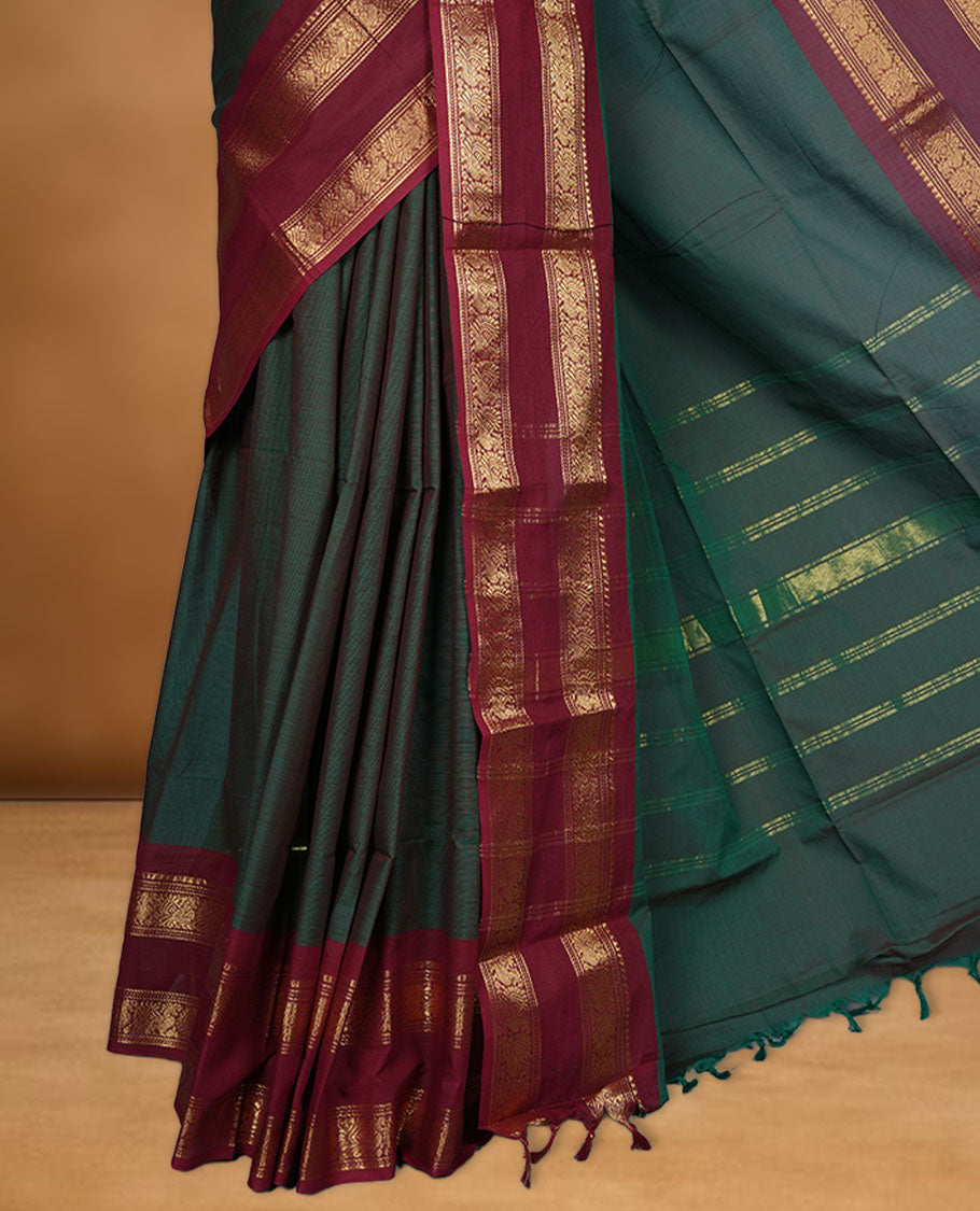 Dark Green colour chettinad cotton saree featuring Elegant plain body, contrast Red colour border with gold zari border, pallu and paired with matching blouse.