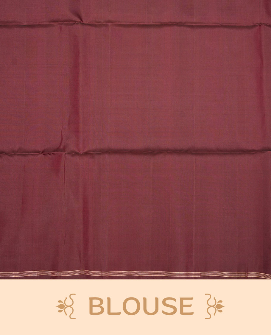 Brown colour soft silk saree featuring gold zari motifs on body, complemented by self colour with traditional border with tassel at pallu, paired with matching blouse piece.