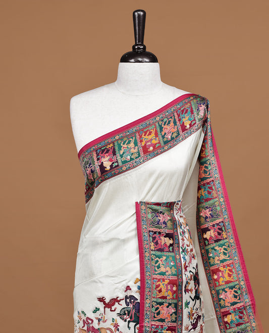 Off white Pashmina silk saree features a minimalist plain body beautifully contrasted by a vibrant red border adorned with multi colored horse and floral kodi motifs, complete with a matching blouse piece.