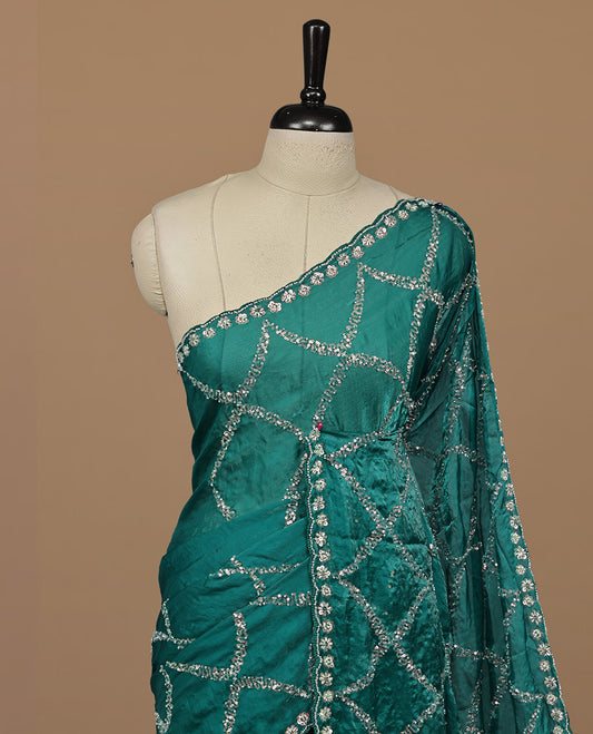 Teal colour designer saree featuring Sequins & cut beats worked body, cut beat worked border, paired with matching unstitched blouse.
