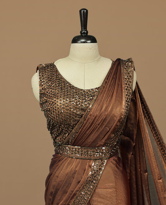 Gold & brown double shade designer saree features Elegant plain body, highlights Sequins & cut beats on border, paired with ready made blouse.