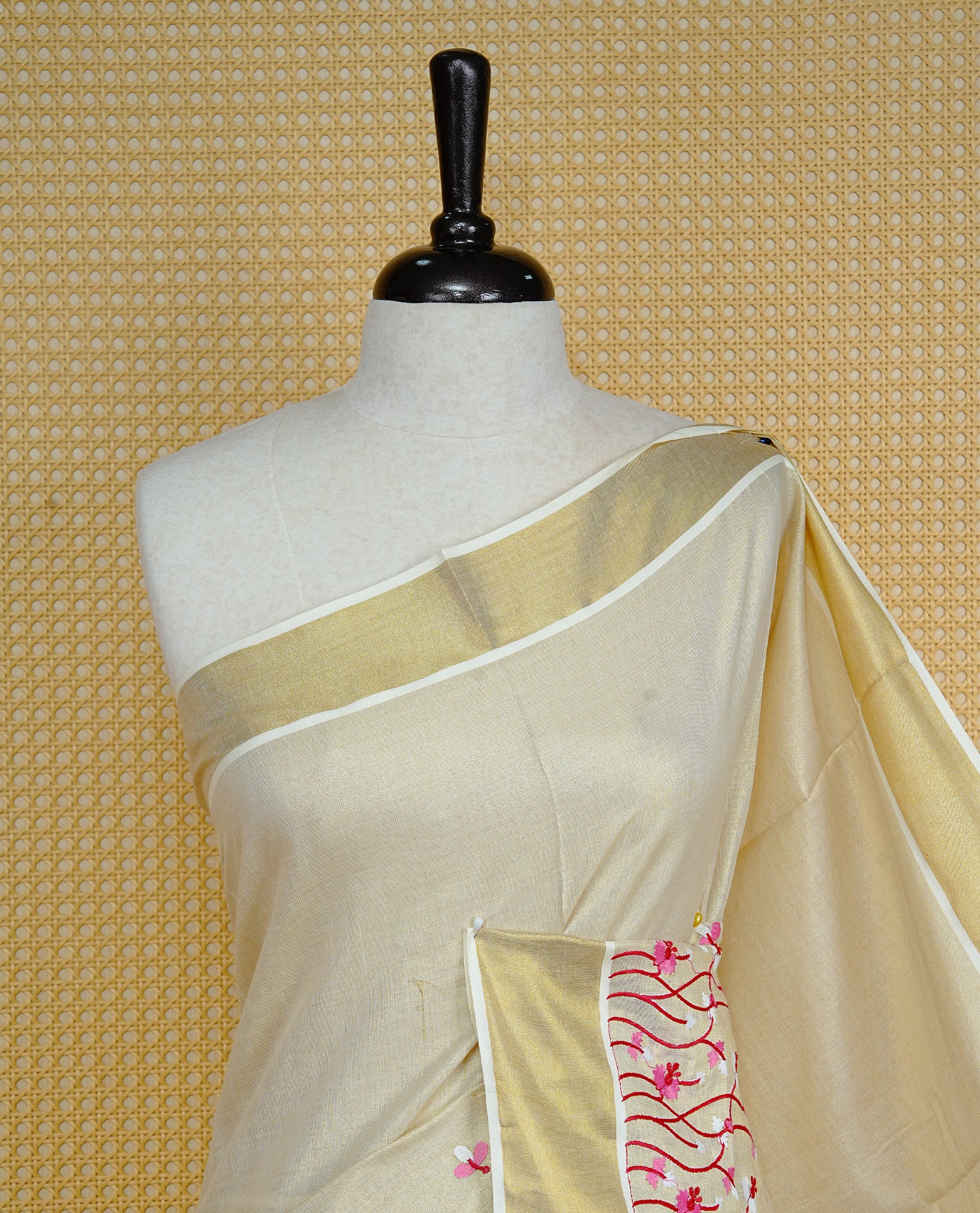 Cream colour Tissue kerala saree featuring Embroidery buttas on body, complemented by Floral thread work & kasavu kara, comes with matching blouse piece.