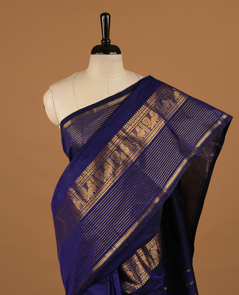 Navy blue colour chettinad cotton saree featuring Elegant plain body, complemented by self colour with zari border, paired with matching blouse piece.