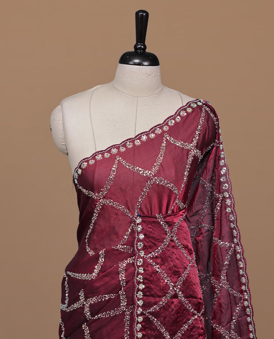 Maroon colour designer saree featuring Sequins & cut beats worked body, cut beat worked border, paired with matching unstitched blouse.