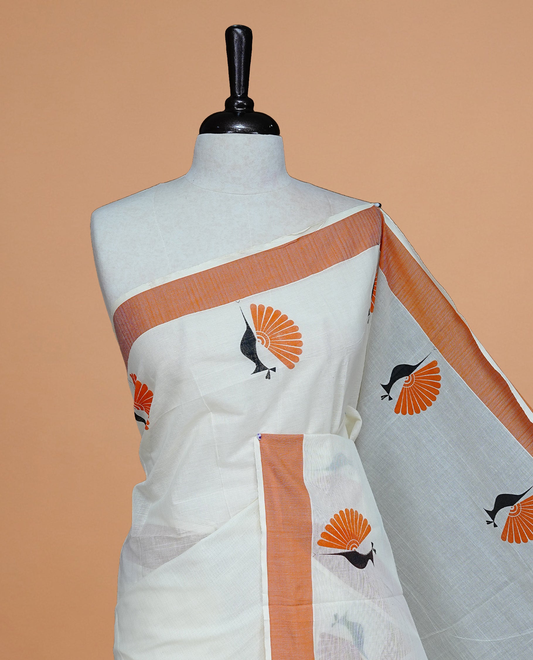 Cream colour Cotton Kerala saree Featuring Classy Plain body for Effortless Elegance, enhancing Orange with Peacock Printed border, paired with matching blouse piece.