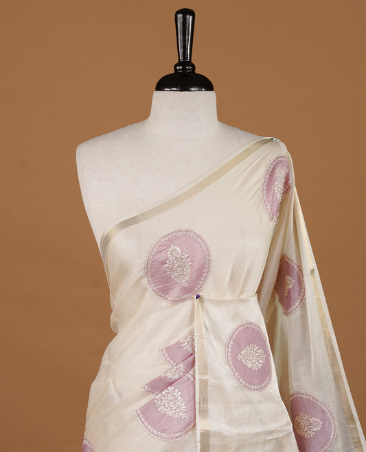 Cream colour Tussar saree featuring mauve colour circle pattern with chikankari embroidery work, highlighting gold zari simple border, paired with matching unstitched blouse.