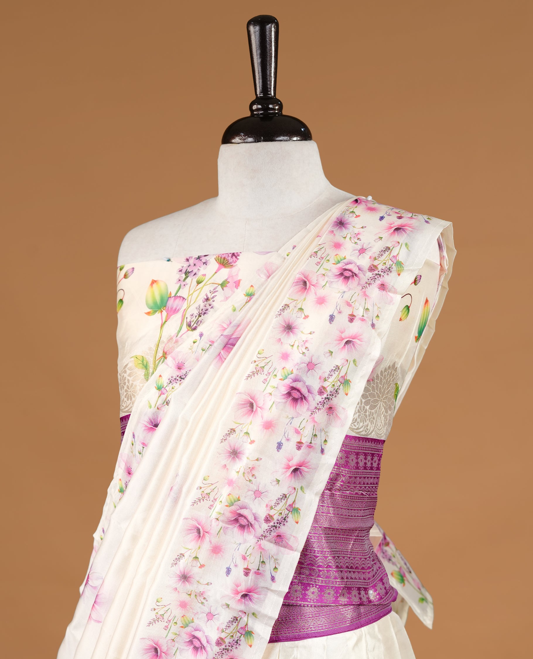 Off white colour semi stitched half saree featuring elegant multicolour floral prints, paired with a light gold border and matching printed dupatta ,paired with matching blouse piece.