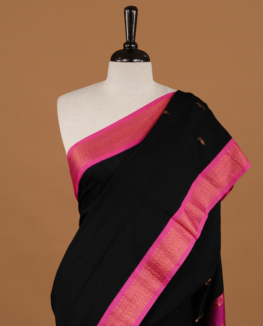 Black colour kalyani cotton saree featuring gold zari motifs on body, highlighting contrast Magenta colour with Antique gold zari border, paired with matching blouse piece.
