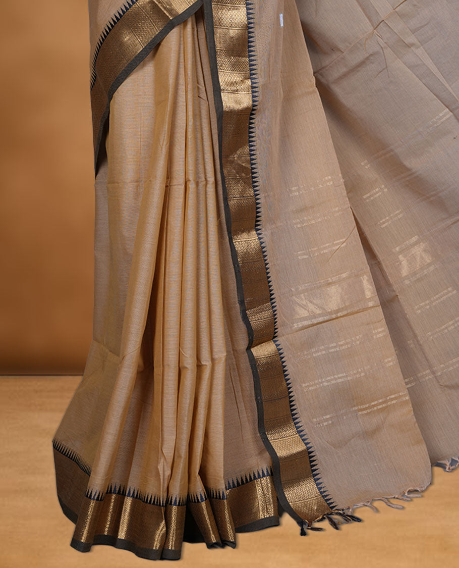 Sandal colour chettinad cotton saree featuring  Elegant plain body, contrast Black colour border with gold zari temple border, pallu and paired with matching blouse