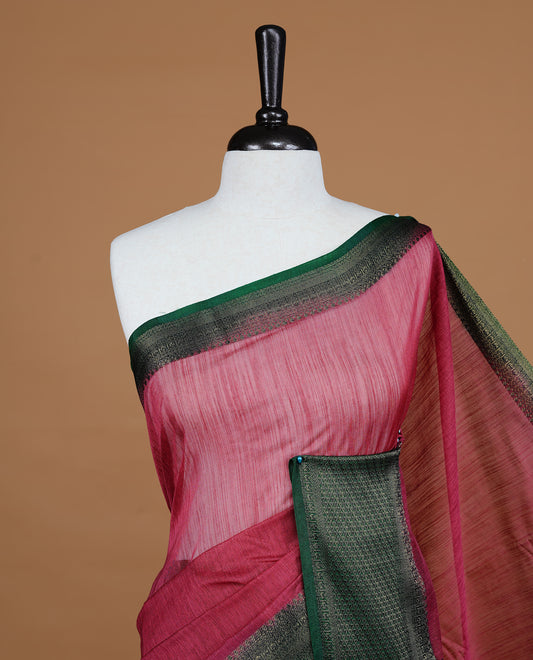 Mauve colour Semi linen saree featuring Elegant plain body, complemented by contrast Green colour With Antique zari border, paired with matching blouse piece.