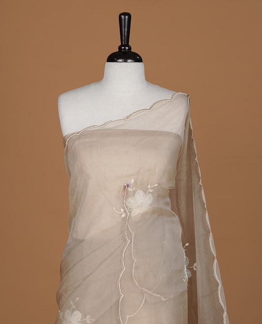 Light coffee colour crush organza saree featuring white floral work with beats & sequins, highlighting scalp with beats worked border, paired with matching blouse piece.