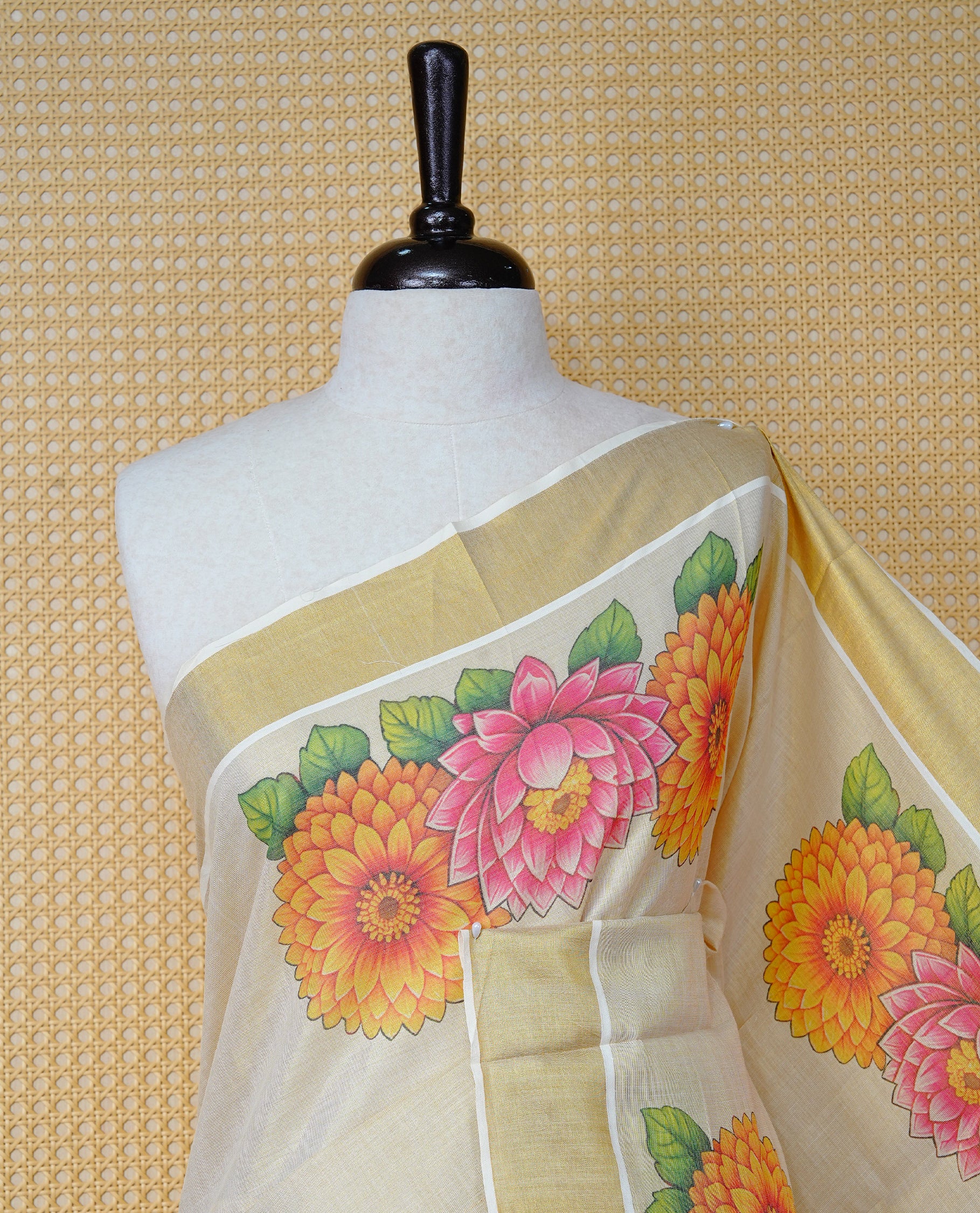Cream Colour Tissue Kerala Saree Featuring Vibrant Digital Floral Prints & Onam Team Printed Pallu, Beautifully Enhanced With A Classic Gold Zari Border And Contrast Tassels. Paired With A Matching Blouse Piece.