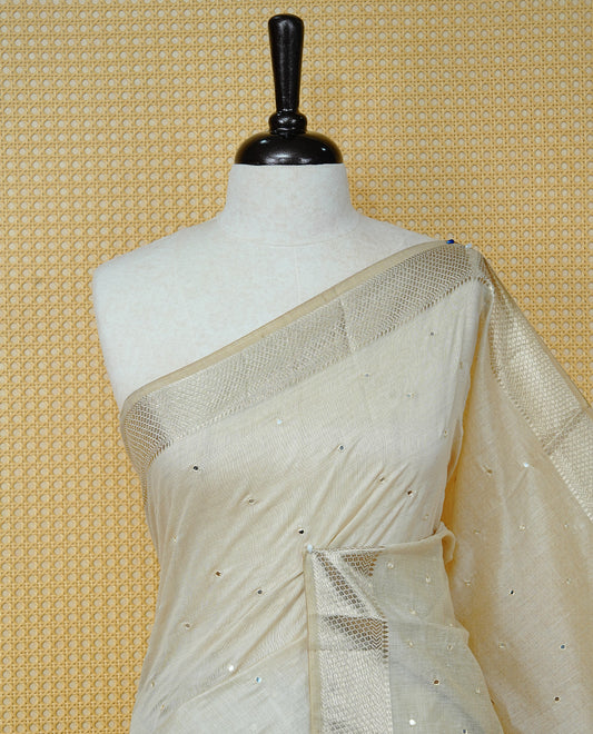 Cream Colour Tussar Kerala Saree Featuring Elegant Mirror Work on the Body, Enhanced with a Light Gold Zari Border, Floral Thread Work, and a Yellow & Gold Zari Pallu, Paired with a Matching Blouse Piece