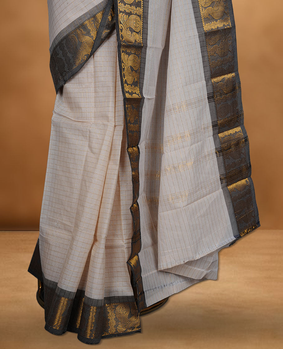 Beige colour chettinad cotton saree featuring gold zari check patterned body, paired with a grey colour traditional gold zari border without blouse.