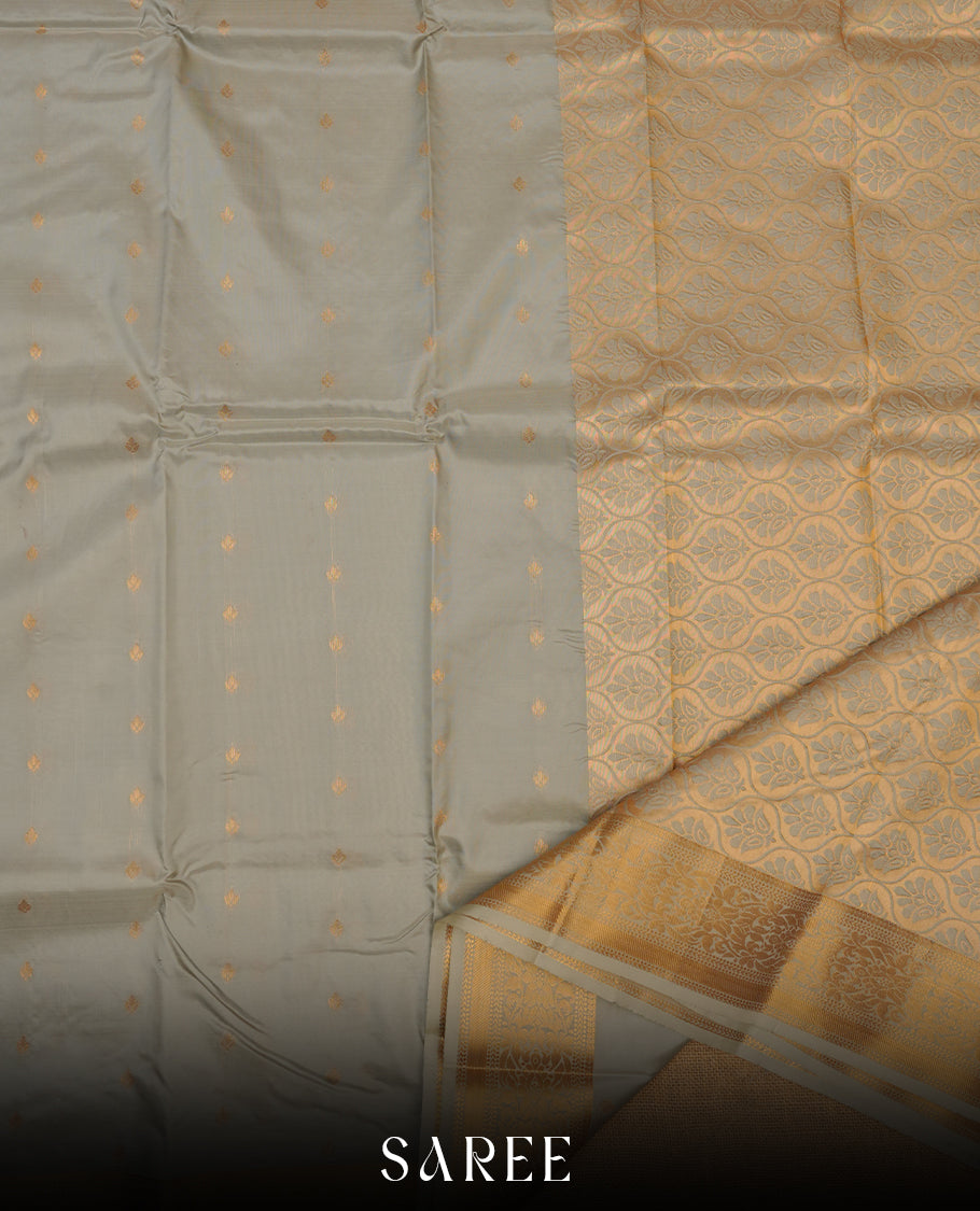 Grey colour shirt and dhoti with silver colour border, paired with matching colour silk saree featuring gold zari buttas and traditional border paired with matching blouse piece.