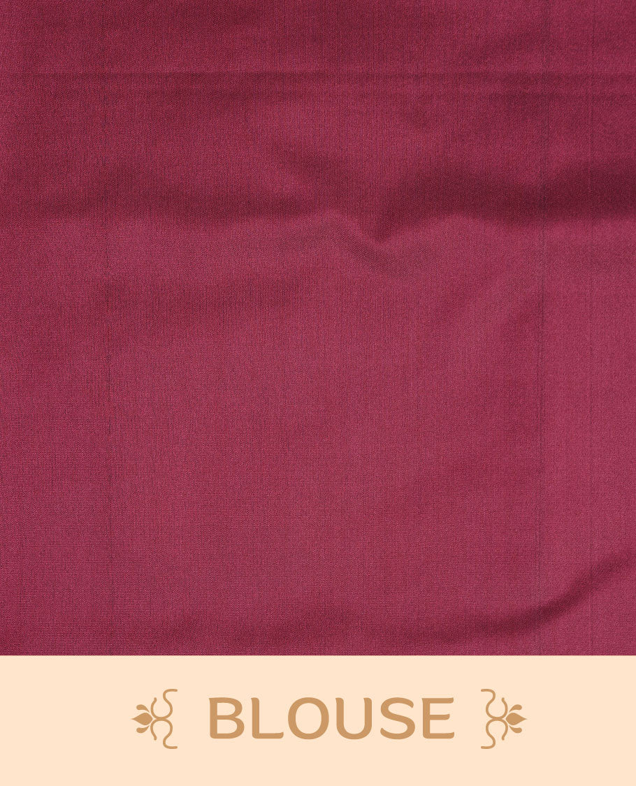 Dusty magenta soft silk saree features a sleek borderless design with intricate antique zari motifs, flowing into a seamless self colored pallu and a matching blouse piece.