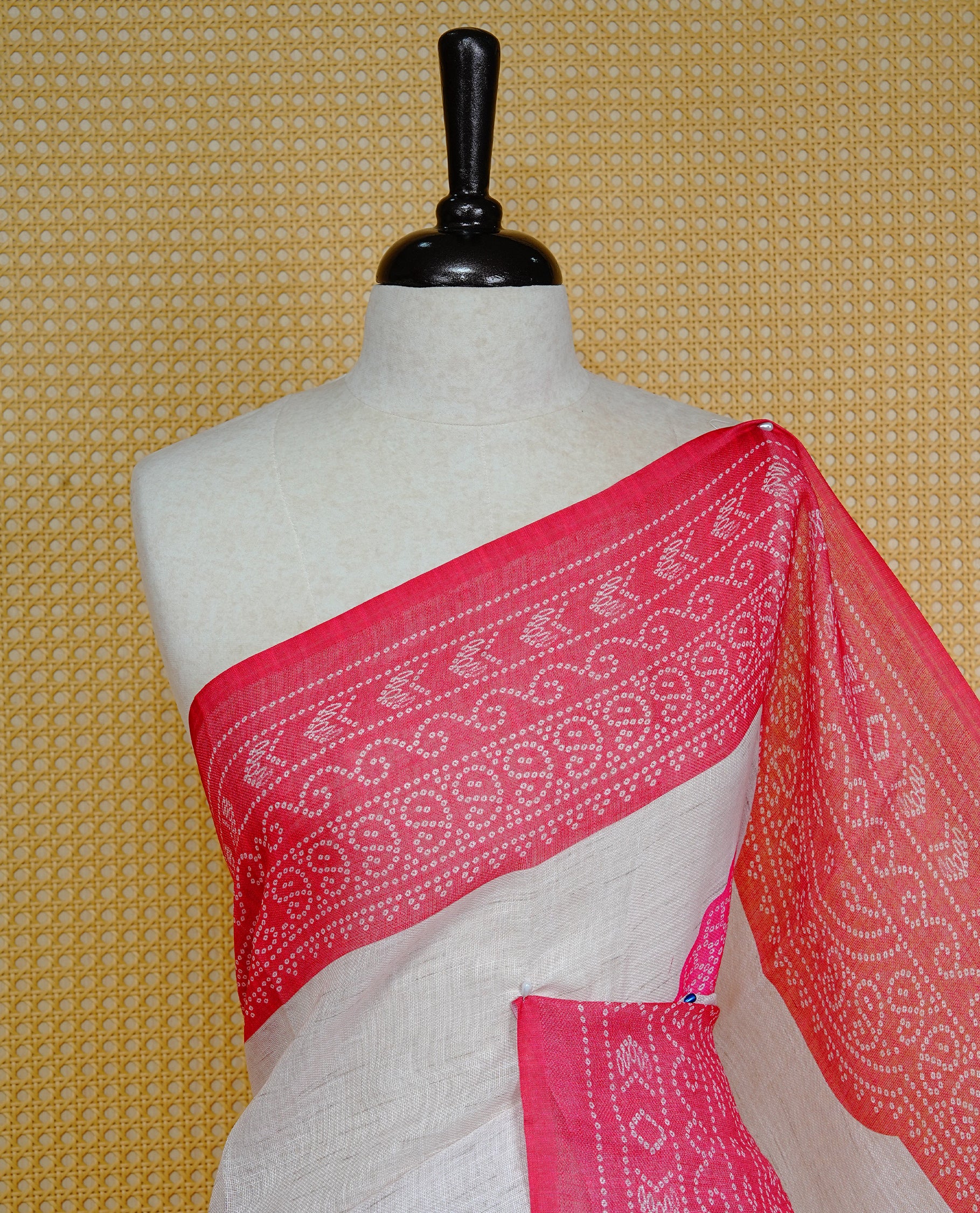 Cream colour semi linen saree featuring Pink Ajrakh pattern print on body, complemented by contrast Red colour with same pattern print border, comes with matching blouse piece.