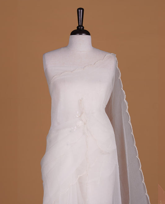 White colour crush organza saree featuring white floral work with beats & sequins, highlighting scalp with beats worked border, paired with matching blouse piece.