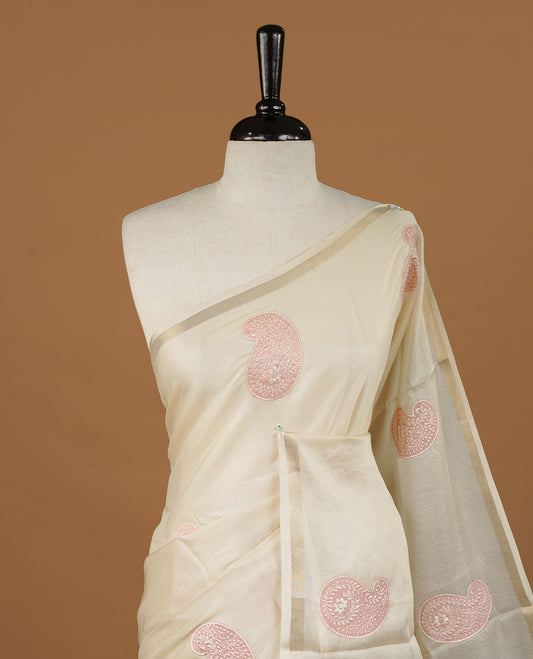 Cream colour Tussar saree featuring pink colour Mango pattern with chikankari embroidery work, highlighting gold zari simple border, paired with matching unstitched blouse.