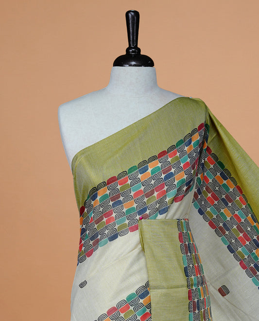 Cream Colour Tissue Kerala Saree Featuring A Classy Multicolour Box Pattern On The Body, Styled With A Green And Gold Zari Border And Pallu, Paired With A Matching Blouse Piece.