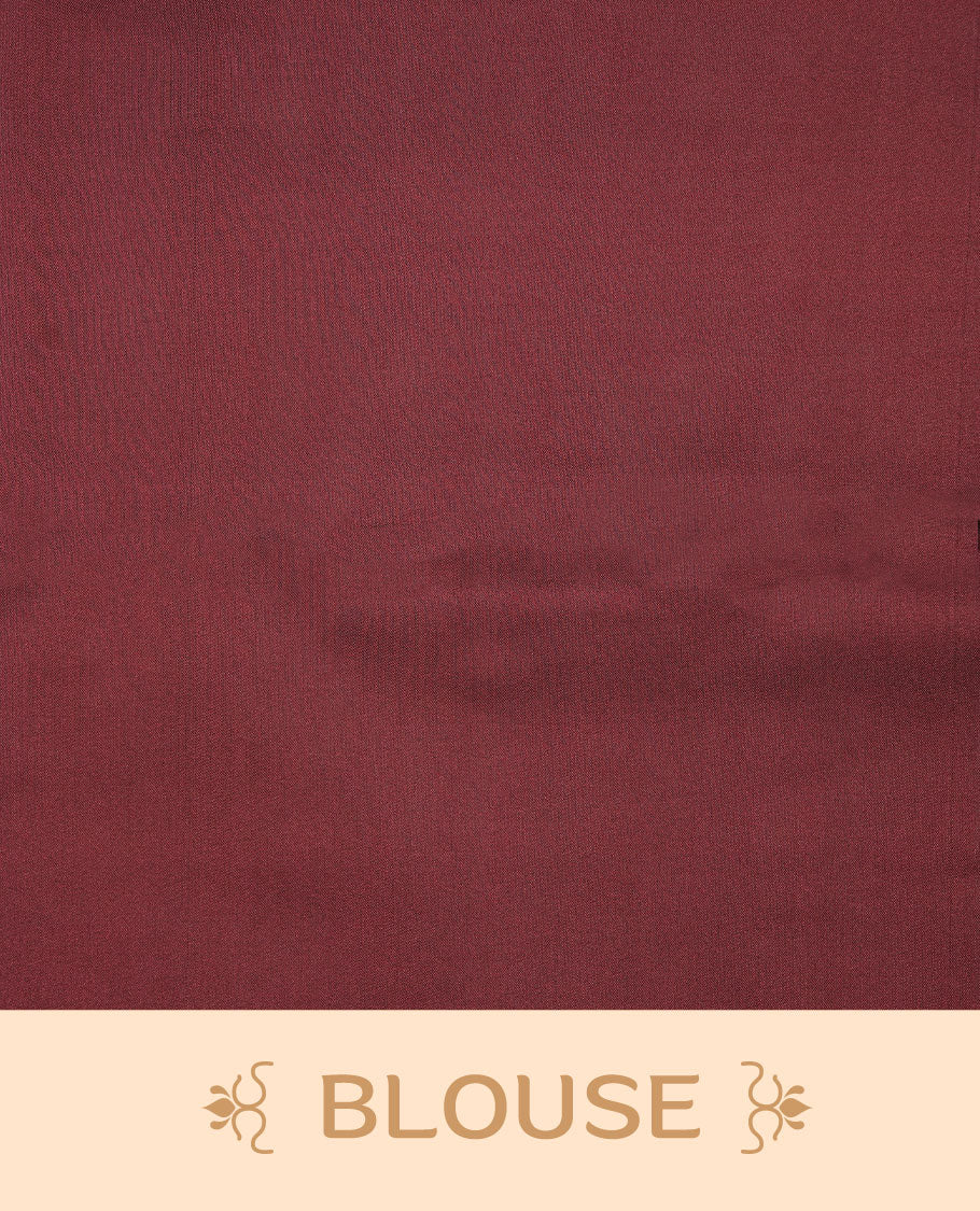 Maroon soft silk saree features a sleek borderless design with intricate antique zari motifs, flowing into a seamless self colored pallu and a matching blouse piece.