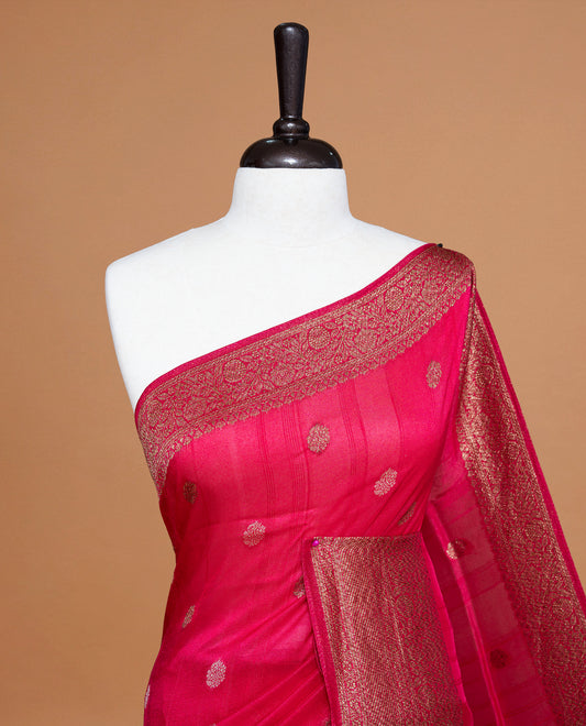 Magenta colour Semi banaras tussar georgette Saree featuring Antique zari motifs on body, enhanced with antique zari border, paired with a matching blouse piece.
