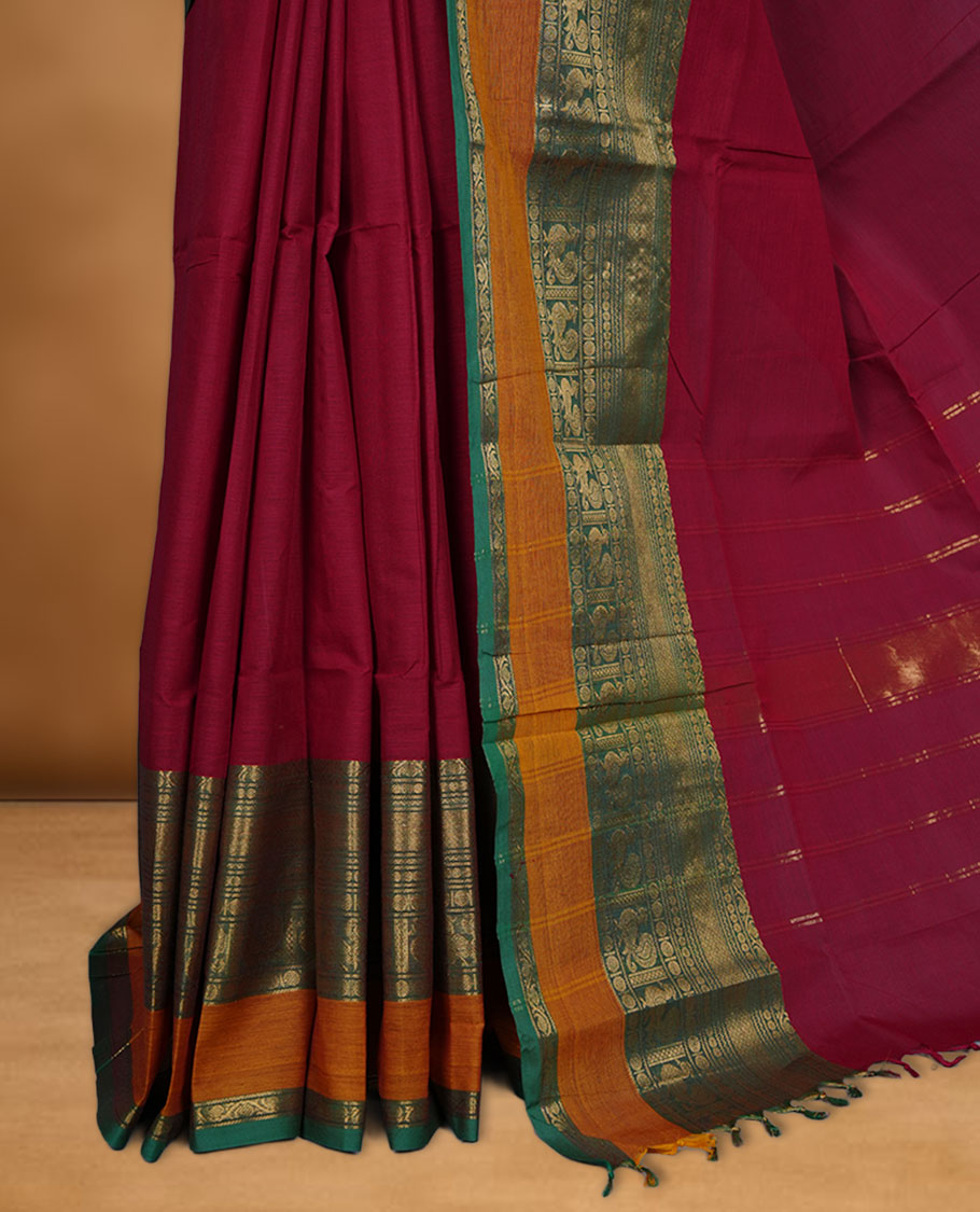 Red colour chettinad cotton saree featuring Elegant plain body highlighting contrast Green and mustrad colour colour with gold zari traditional border, pallu and paired with matching blouse piece.