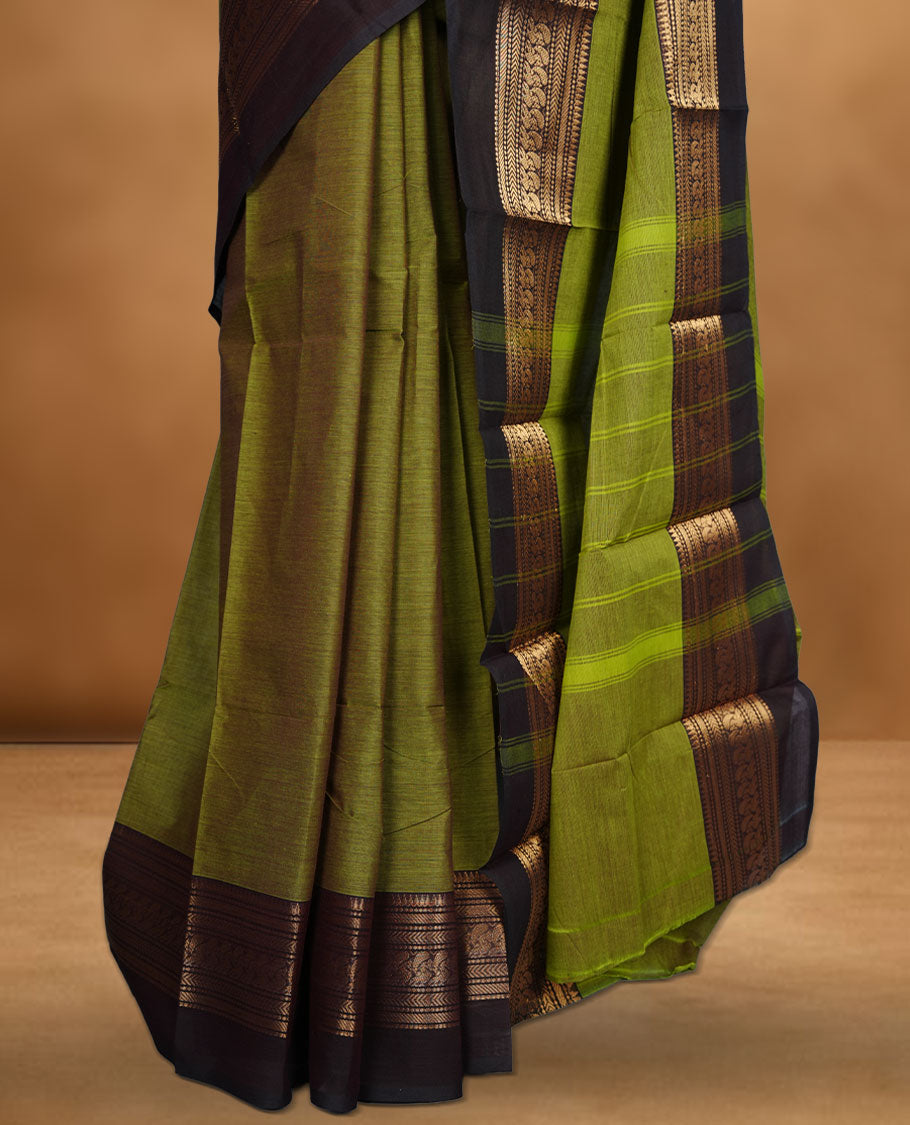 Olive green colour chettinad cotton saree featuring plain body, contrast Dark Brown colour with traditional gold zari border without blouse.