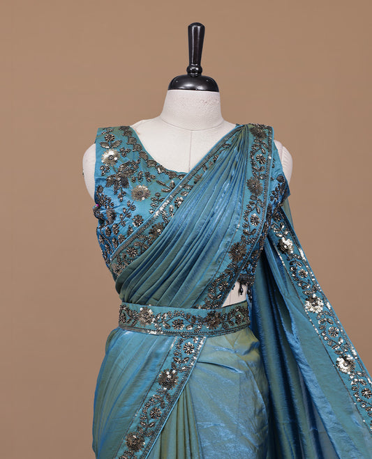 Gold & blue double shade designer saree features Elegant plain body, highlights Sequins & cut beats on border, paired with ready made blouse.