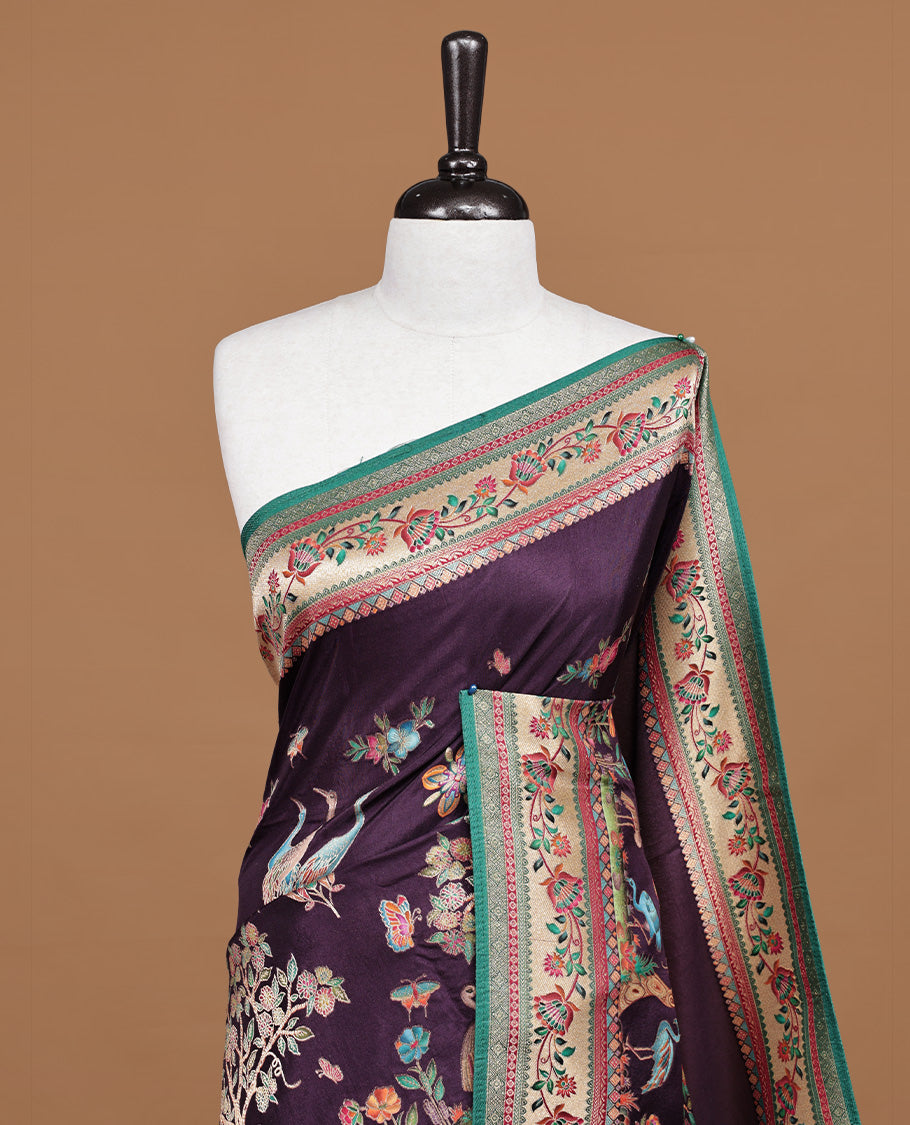 Deep purple colour Pashmina silk saree features an all over forest body, a contrast cream & green floral kodi border and pallu, and a matching unstitched blouse.