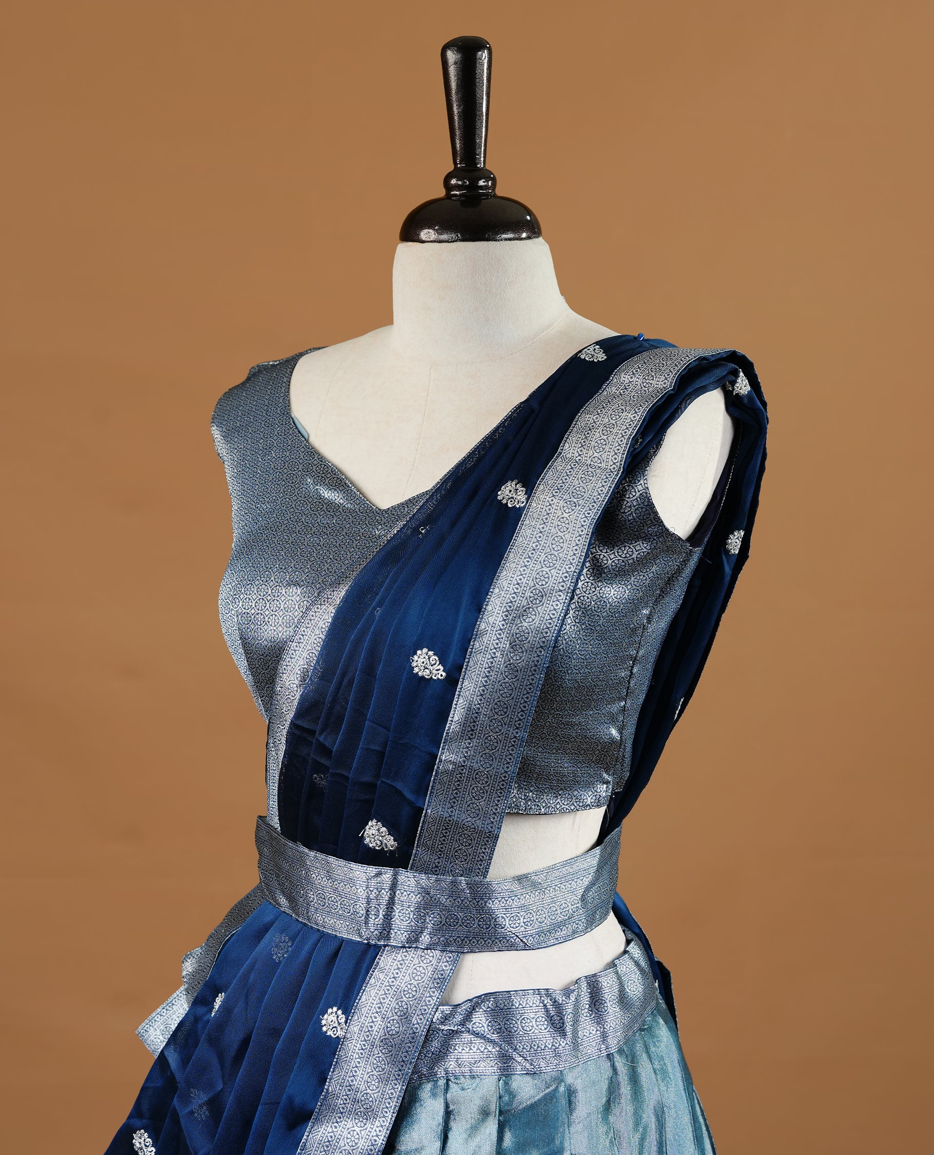 Bluish silver colour Half saree featuring Bluish silver skirt with contrast dark blue colour with silver zari traditional with floral pattern border, paired with matching dupatta, stitched blouse piece.