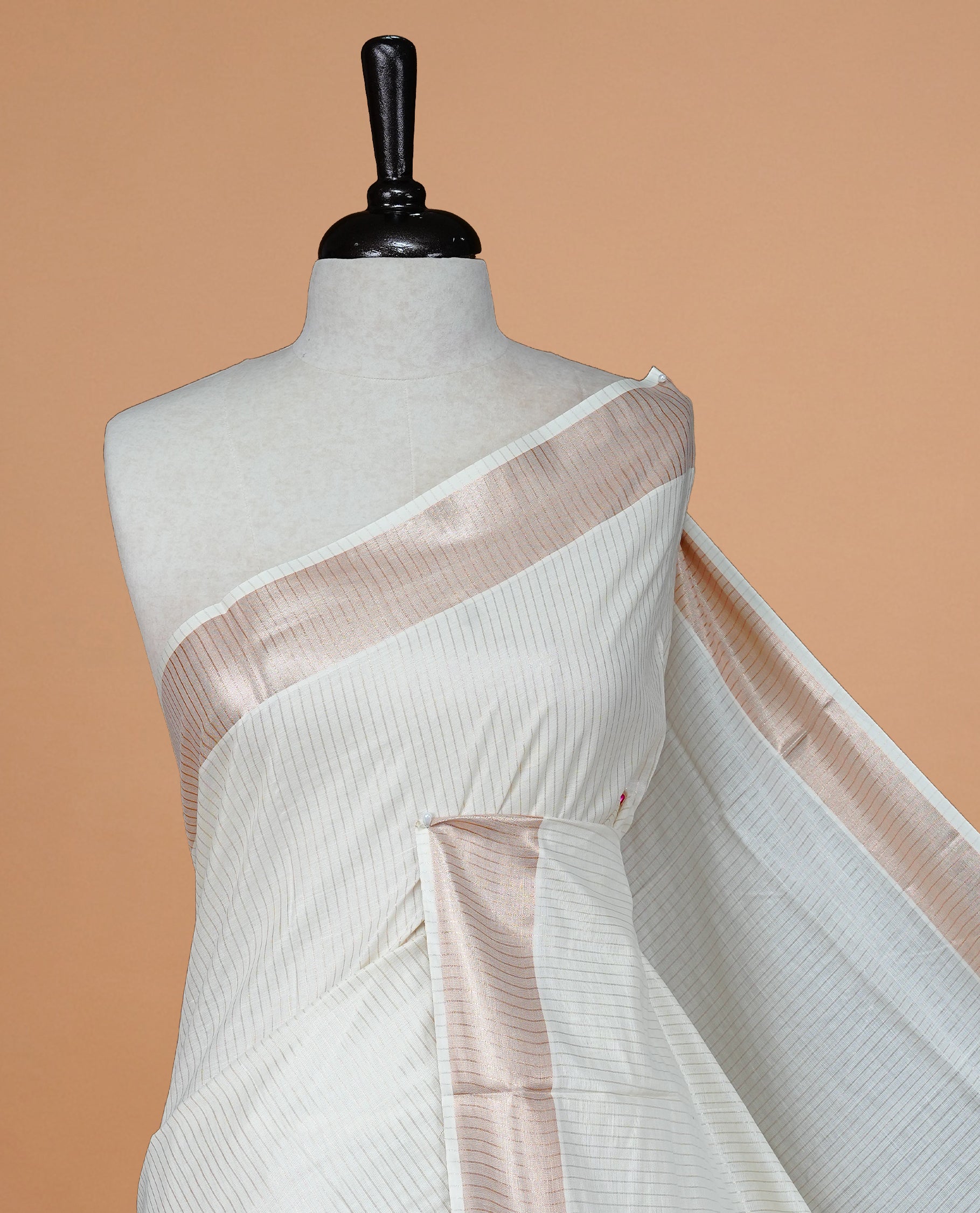 Cream colour Kerala saree featuring Rose Gold stripes on body, enrich by classy zari Border, pallu ,comes with matching blouse piece.
