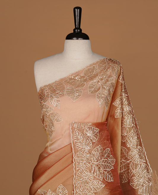 Orange & gold double shade organza saree featuring thread & cut beats, sequins leaf pattern on body, highlighting scalp border, paired with matching blouse piece.