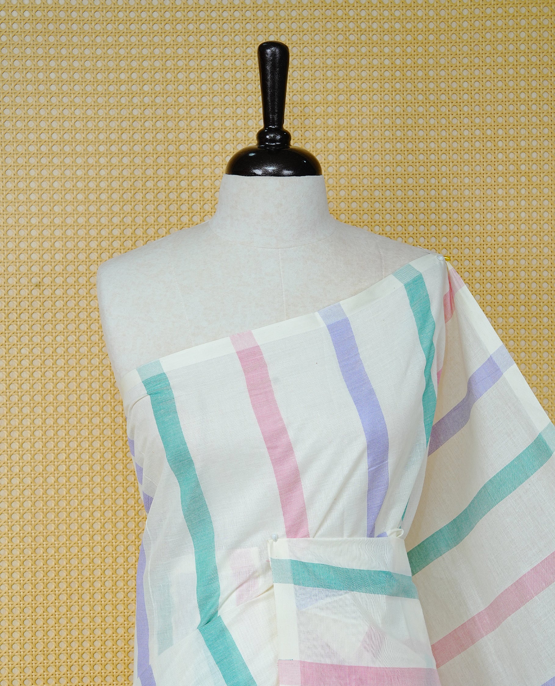 Cream colour Cotton kerala saree featuring Pink, green, purple colour stripes on body,  Finished with tassels on Pallu, paired with matching blouse piece.