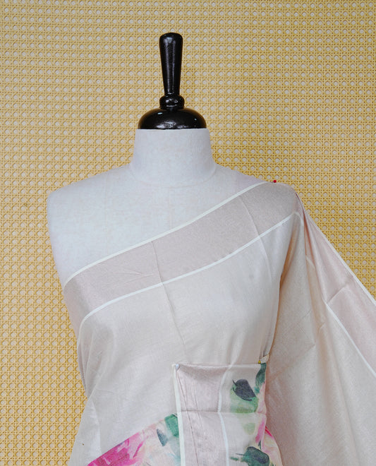 Cream Colour Tissue Kerala Saree Featuring Digital Floral Prints Across The Body, Enhanced With A Rose Gold Zari Border, Finished With Pink & Green Tassels And A Matching Blouse Piece