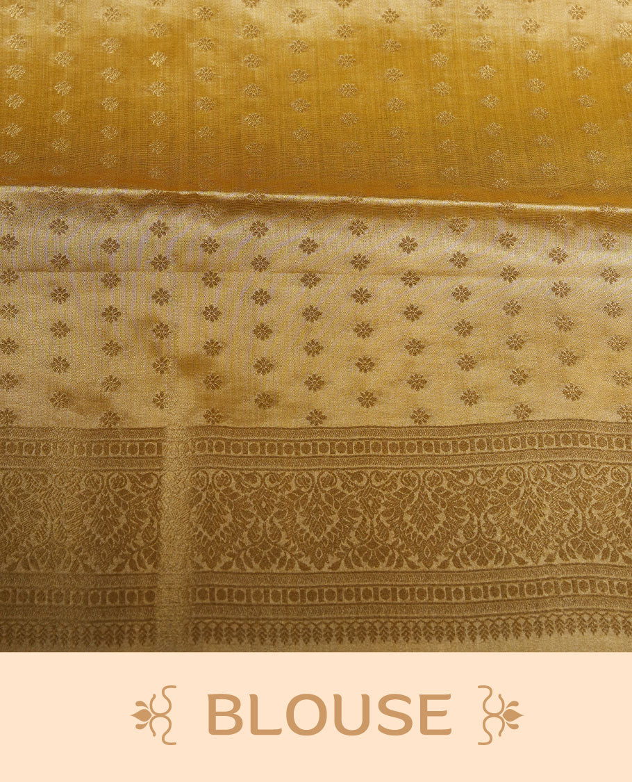 Gold colour tissue brocade saree featuring all-over zari floral motifs on the body, a rich traditional zari border and an intricately woven pallu, paired with a matching blouse piece.