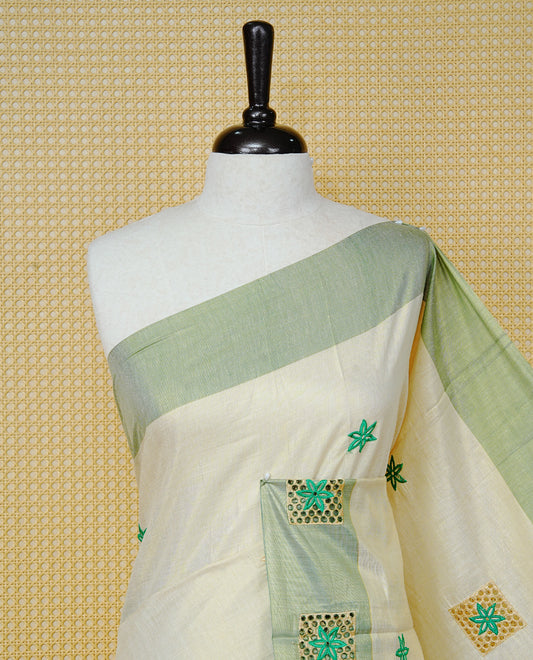 Cream Colour Tissue Kerala Saree Featuring Delicate Green  Floral Embroidery Work Across The Body, Enhanced With A Light Green  Zari Border And A Rich Green & Gold Zari Pallu, Finished With Green Tassels And A Matching Blouse Piece