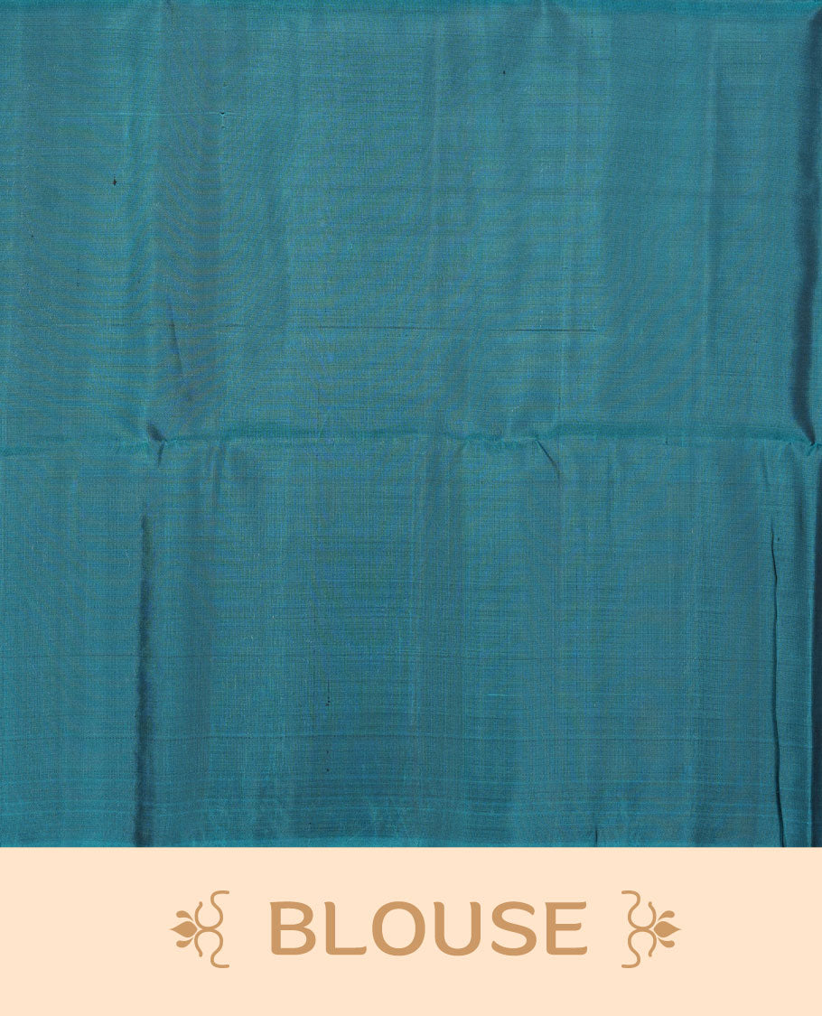 Teal colour soft silk saree featuring silver zari motifs on body, complemented by self colour with traditional border with tassel at pallu, paired with matching blouse piece.