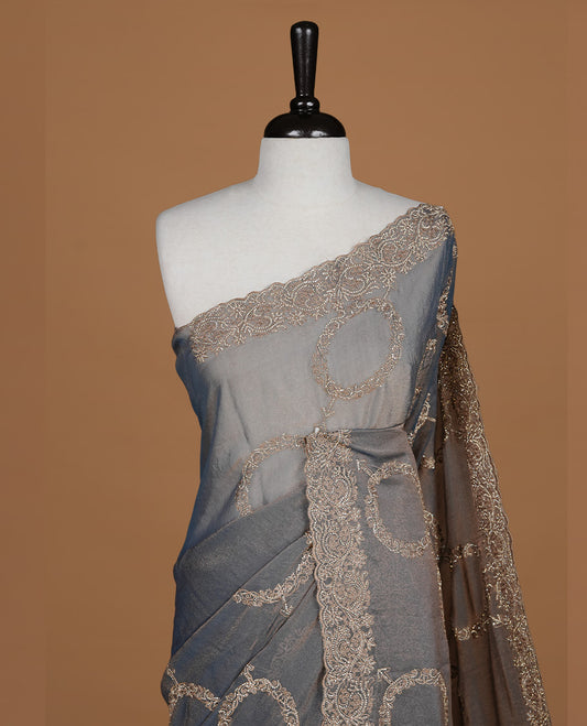 Blue colour organza saree featuring thread & gold stone pattern on body, highlighting scalp border, paired with mtahcing blouse piece.