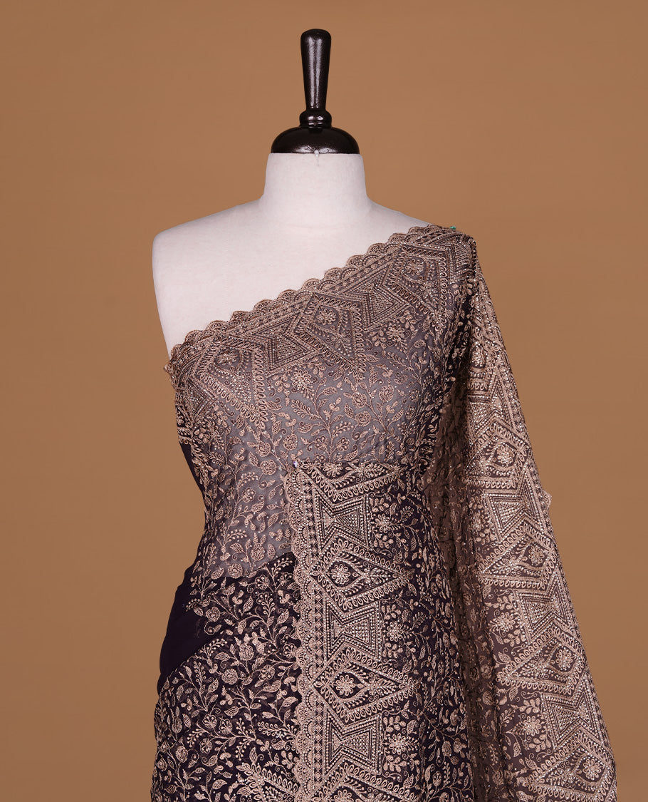 Maroon colour georgette designer saree featuring Gold thread floral pattern on body highlighting with stone and scalp border, paired with matching blouse piece.