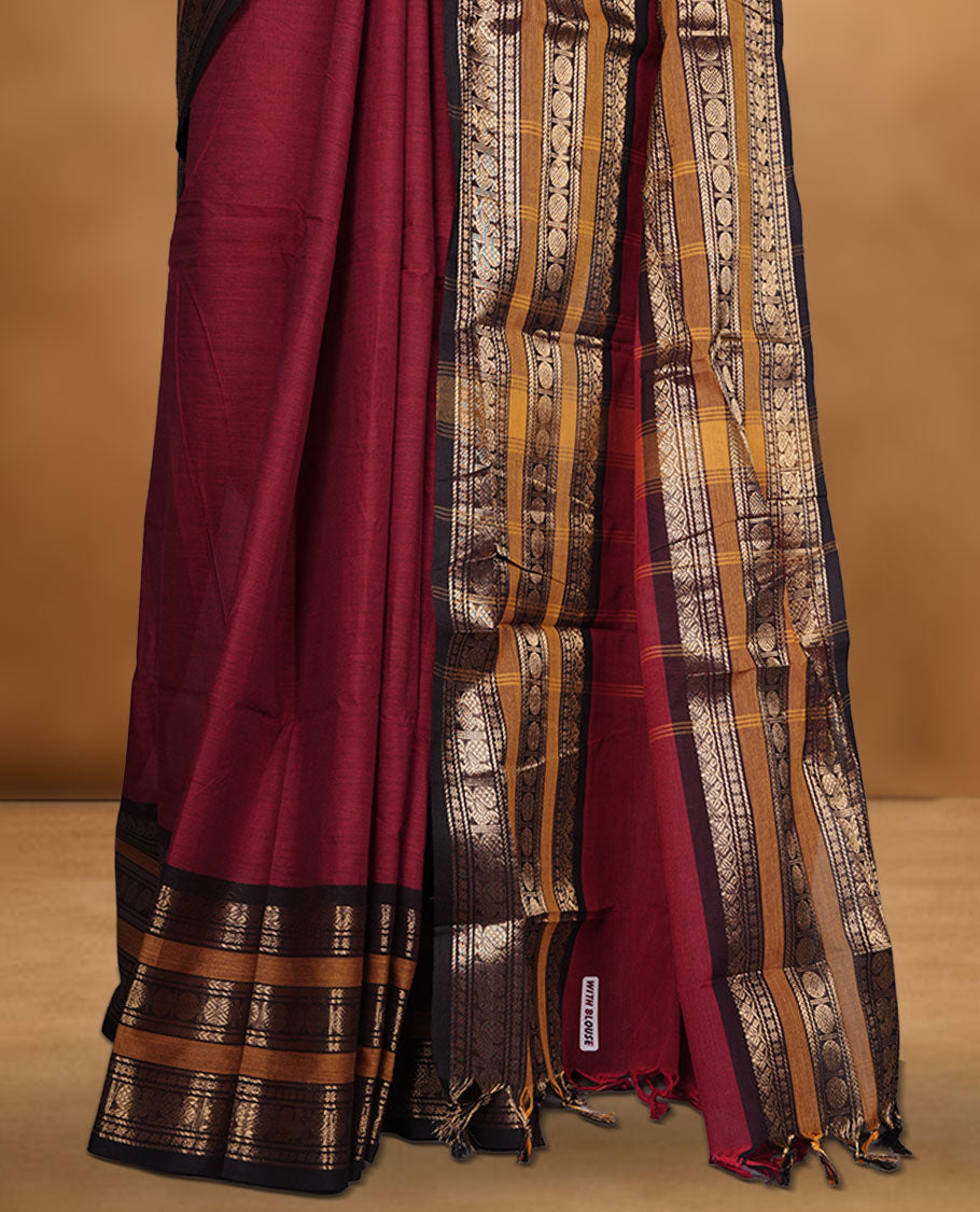 Maroon colour chettinad cotton saree featuring plain body, contrast chocolate brown and mustard colour with traditional gold zari border paired with matching blouse.