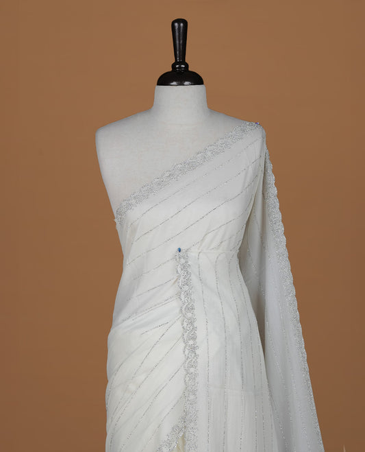 Off white colour designer saree featuring white stone stripes on body, highlighting white stone with scalp border, paired with matching blouse piece.